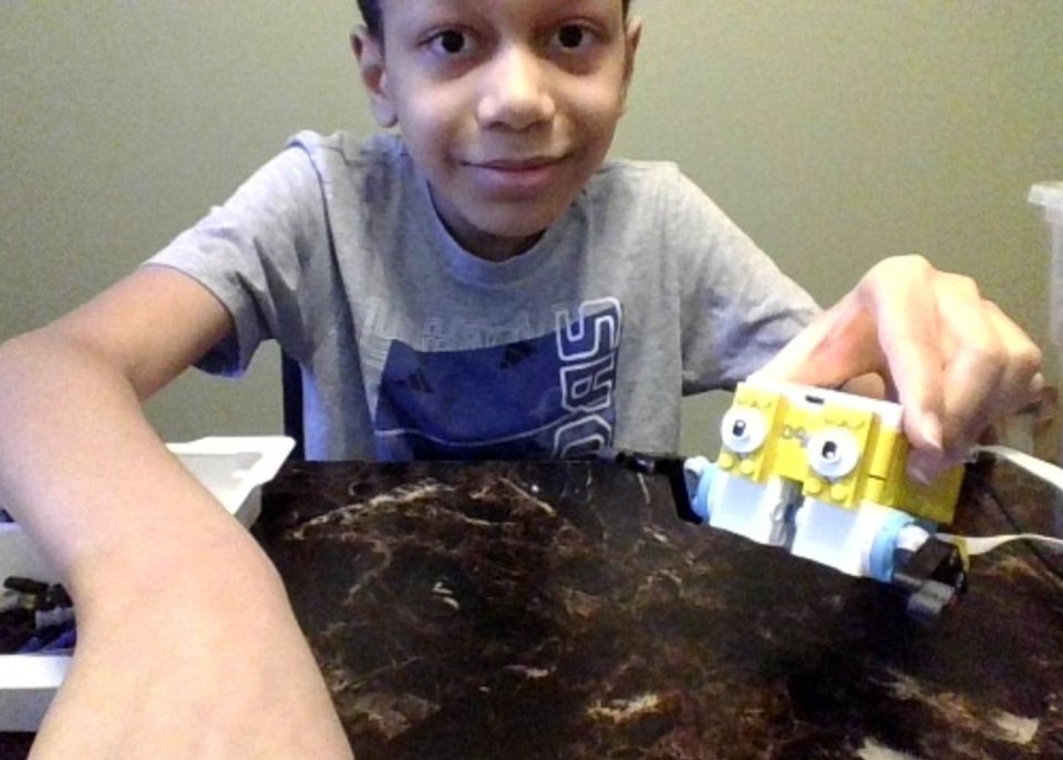 boy holding lego robot